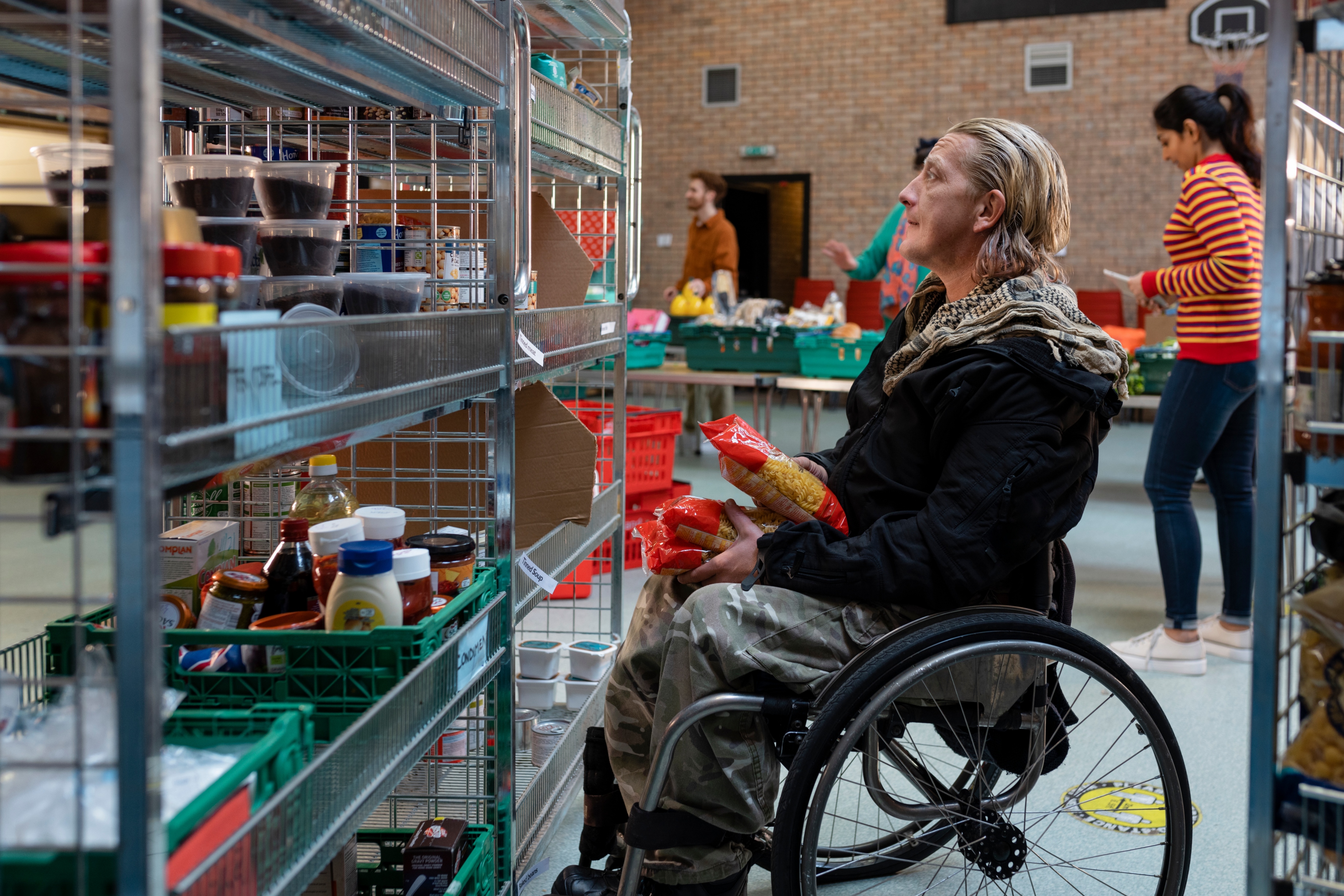 side view of a wheelchair user at a food bank
