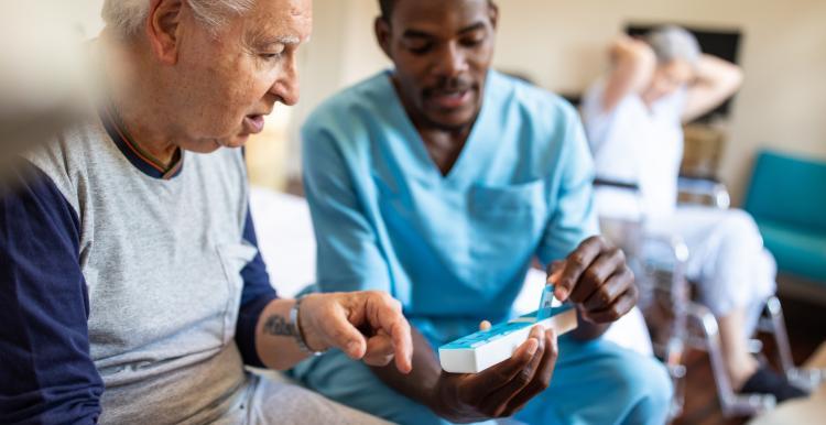 nurse sitting on bed giving instructions