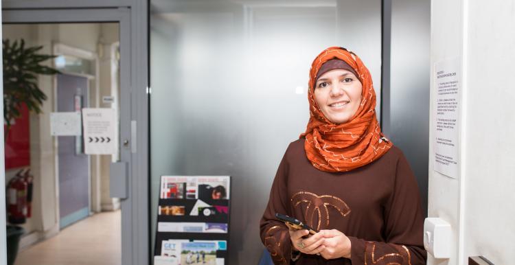 Woman in a meeting room smiling at the camera 