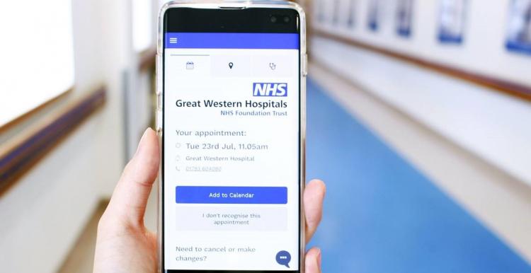 Picture of a hand holding a phone showing Great Western Hospital online booking tool