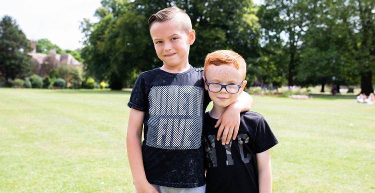 two children at an outdoor event looking at the camera