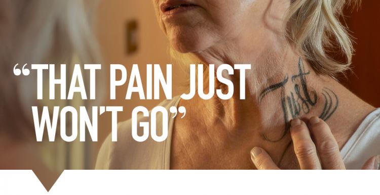 Woman holding on her neck with 'Just' tattoo 