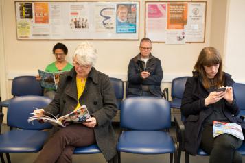 Picture of people sitting in a waiting room in a medical setting