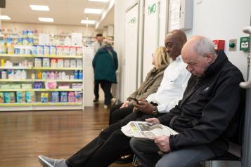 Shot of pharmacy with people waiting in a reception area
