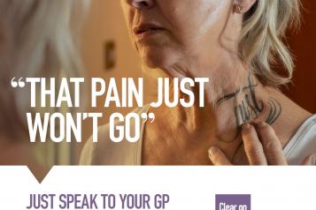 Woman holding on her neck with 'Just' tattoo 