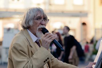 Older man with microphone singing