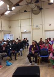 The Nepalese Association of Wiltshire sitting in a large hall